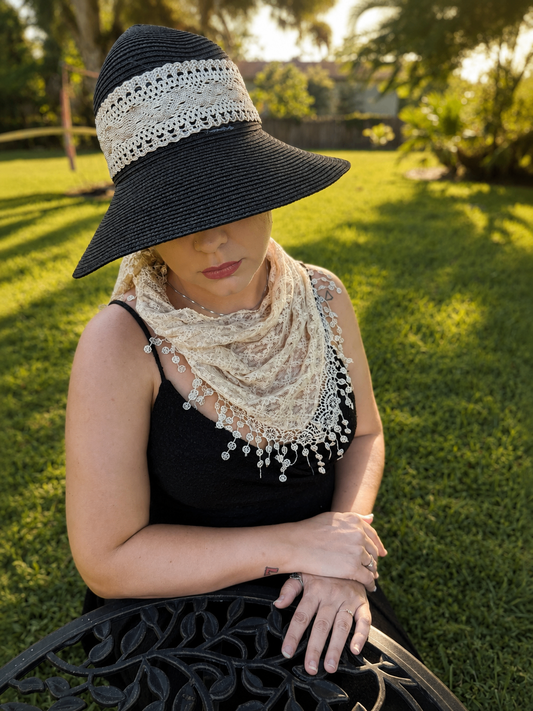 Woman on a coastal boardwalk styled with a lightweight scarf