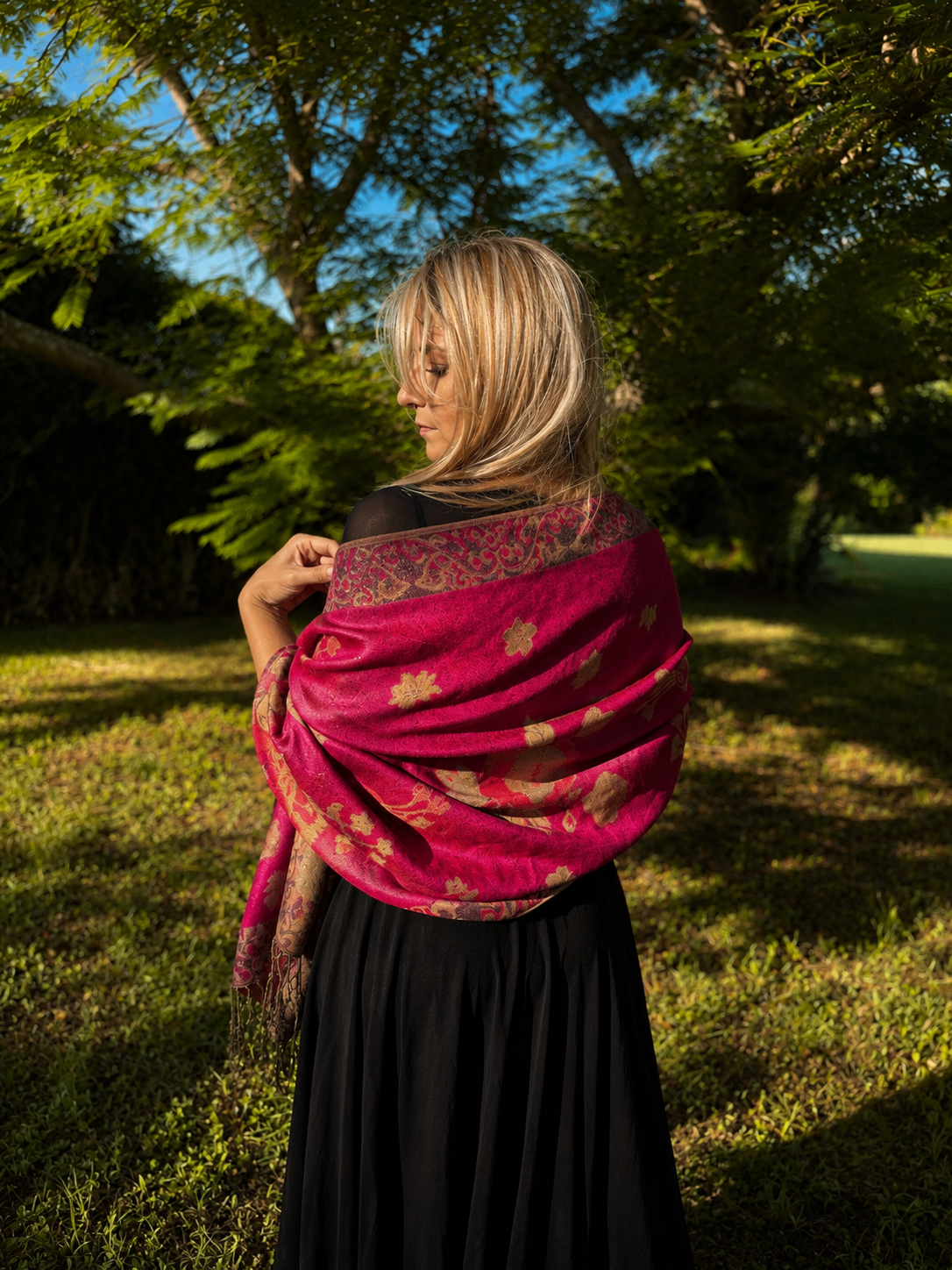 Three folded lightweight knit scarves in coastal colors with seashells